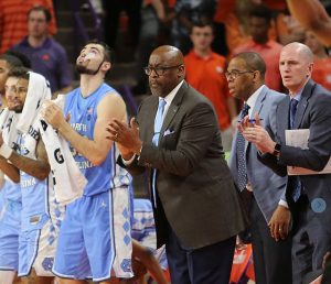 Assistant coach Steve Robinson, center, had to take over and coach the entire second half after UNC coach Roy Williams went out with vertigo. (UNC Sports Information photo by Dawson Powers.)