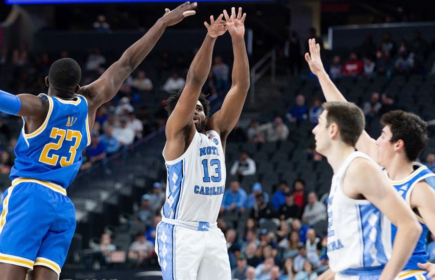 UNC's Jeremiah Francis gets a shot off, barely. (UNC Athletic Communications)