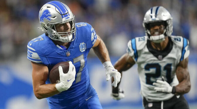 Detroit Lions tight end Sam LaPorta (87) carries on a touchdown reception as Carolina Panthers safety Jeremy Chinn (21) pursues in the first half of an NFL football game in Detroit, Sunday, Oct. 8, 2023. (AP Photo/Paul Sancya)