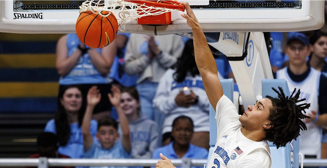 Schools are snatching up transfers in college hoops, meaning fewer freshmen North Carolina's Elliot Cadeau dunks during the second half of an NCAA college basketball exhibition game against Saint Augustine's in Chapel Hill, N.C., Friday, Oct. 27, 2023. (AP Photo/Ben McKeown)