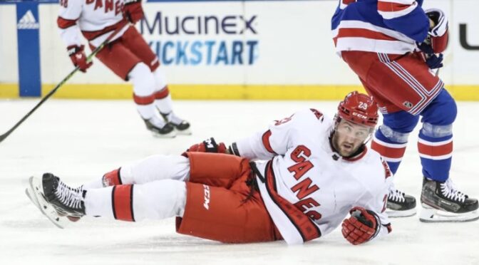 Carolina Hurricanes right wing Stefan Noesen (23) falls on the ice after a collision in the first period against the New York Rangers at Madison Square Garden. Mandatory Credit: Wendell Cruz-USA TODAY SportsWendell Cruz/USA TODAY Sports via Reuters.