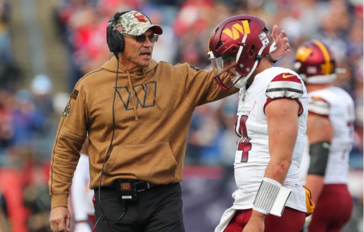 Coach consoles Sam Howell after he throws inexplicable end-zone interception directly to Patriots S Kyle Dugger.
