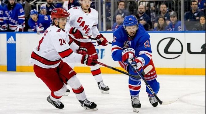 Carolina Hurricanes center Seth Jarvis (24) defends against New York Rangers center Nick Bonino (12) during the second period of an NHL hockey game in New York, Tuesday, Jan. 2, 2024. (AP Photo/Peter K. Afriyie)