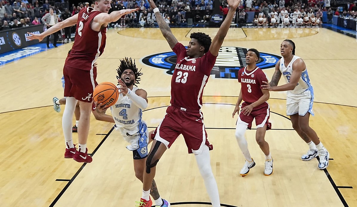Davis, Heels lose lead as season ends at the hands of Alabama North Carolina guard RJ Davis (4) drives to the basket between Alabama forward Grant Nelson (2) and forward Nick Pringle (23) during the second half of a Sweet 16 college basketball game in the NCAA tournament Thursday, March 28, 2024, in Los Angeles. (AP Photo/Ashley Landis)