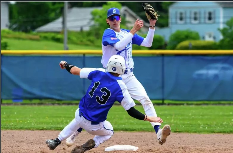New York high school pitcher chooses his favorite team – the Tar Heels Shaker shortstop Sean Hurley tries to turn two after forcing out Saratoga baserunner Brady Mills during the Class AAA semifinals on Saturday, May 18, 2024, in Colonie, NY. Jim Franco/Times Union