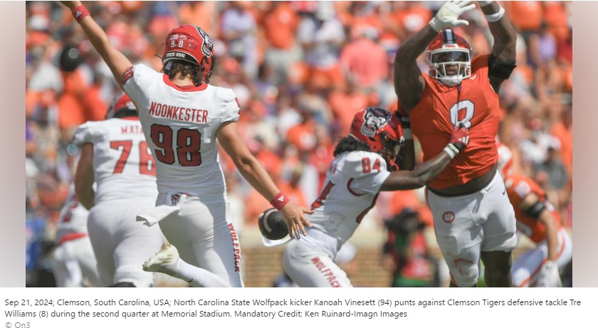 Sep 21, 2024; Clemson, South Carolina, USA; North Carolina State Wolfpack kicker Kanoah Vinesett (94) punts against Clemson Tigers defensive tackle Tre Williams (8) during the second quarter at Memorial Stadium. Mandatory Credit: Ken Ruinard-Imagn Images © On3