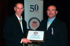 Scott Campbell, left, accepts award from Greg Pierce, representing the Raleigh Sports Club.