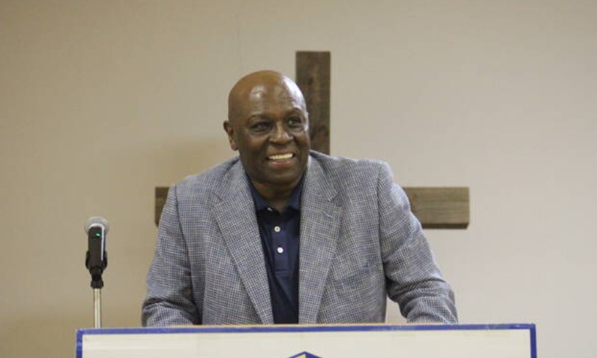 Former North Carolina and NBA basketball player Phil Ford smiles after walking up on stage during the Fellowship of Christian Athletes fundraiser banquet Thursday night at Laurinburg Presbyterian Church. Photos| Brandon Hodge/ The Exchange and Daily Journal.