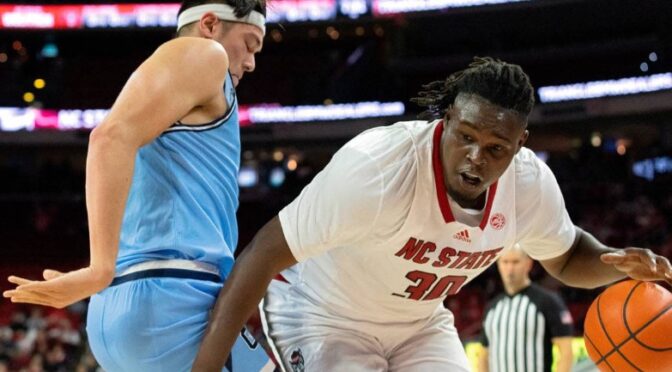 N.C. State’s DJ Burns Jr. drives baseline past the Citadel’s Quentin Millora-Brown during the first half of the Wolfpack’s season opener against The Citadel on Monday, Nov. 6, 2023, at PNC Arena in Raleigh, N.C.Kaitlin McKeown/kmckeown@newsobserver.com