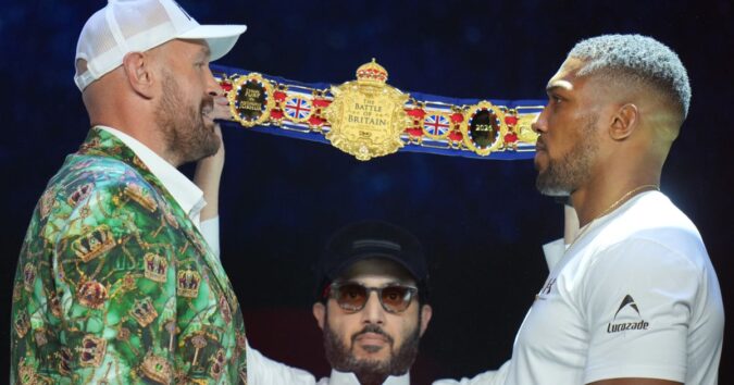 Fury and Joshua are mostly smiles as they take stage together ahead of Cardiff bout