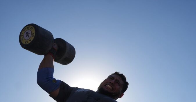 Burly men in Gaza pull trucks and flip tires in competition of strength